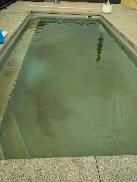 Pool with murky green water before Akwa Pools treated it
